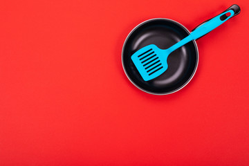 Cooking utensils in kitchen isolated with copyspace on red background