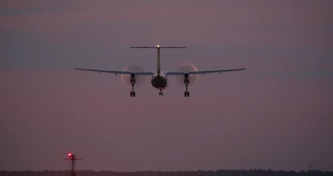 4K - Turboprop aircraft landing at night on runway