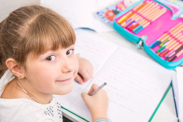 young girl is doing homework