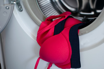 Pink woman underwear in the washing machine
