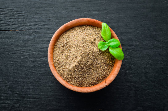 Black ground pepper. Spices Top view. On the old background.