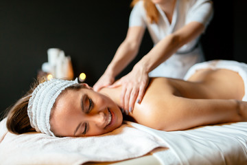 Obraz na płótnie Canvas Massage therapist massaging woman