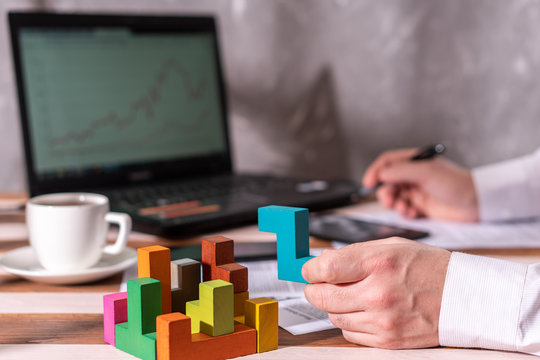 Businessman with conundrum at table in office.