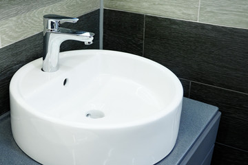 Bathroom interior with circle sink and faucet
