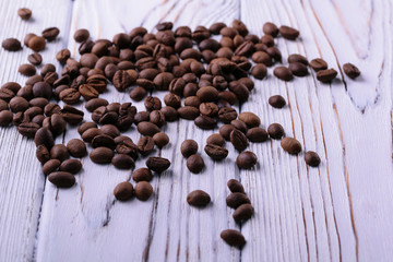 coffee beans in shape of heart on wooden background