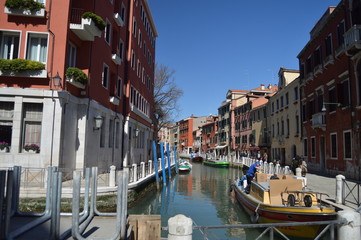 Fototapeta na wymiar Narrow Canals With Boats Moored On Piers Of Buildings In Venice. Travel, Holidays, Architecture. March 27, 2015. Venice, Region Of Veneto, Italy.