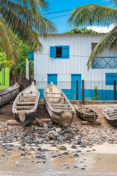     Sao Tome, dugouts on the beach in fishermen's village, typical houses 