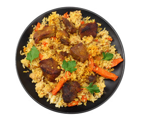 pilaf with meat on black plate isolated on white background. top view