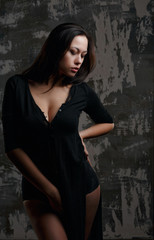 Fototapeta na wymiar Studio portrait of young sexy model with perfect body posing with shadows