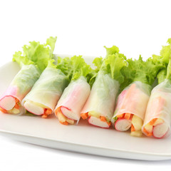 Fresh vegetable salad roll in noodle tube on dish isolated on wh