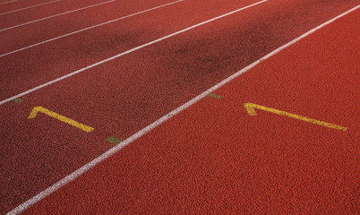 Fototapeta premium Top view of empty red racetrack for athletics