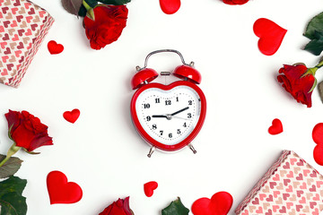 Romantic alarm clock with gifts, rose flowers and decorative hearts on white background. St. Valentines Day concept.