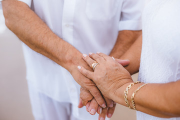 Hands together of an older couple