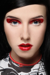 Glamorous portrait of beautiful girl with fancy red eyeshadow and lipstick