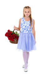 Cute little girl with a basket of flowers.
