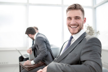 successful businessman sitting in an office waiting room