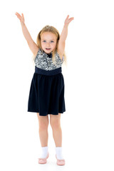 Joyful girl with arms raised.