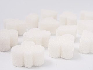 white lump sugar refined on a white background.