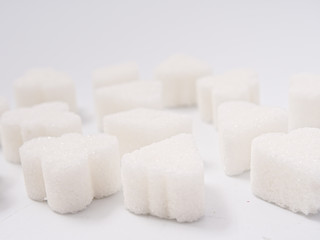 white lump sugar refined on a white background.