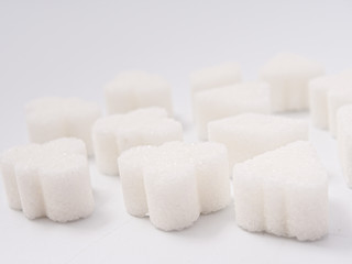 white lump sugar refined on a white background.