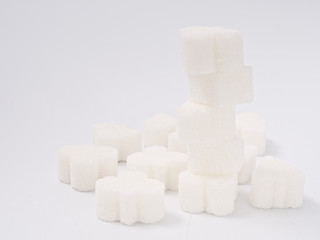 white lump sugar refined on a white background.