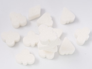 Fototapeta na wymiar white lump sugar refined on a white background.