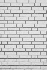 Obraz premium white brick wall with gray grouting, vertical background texture pattern