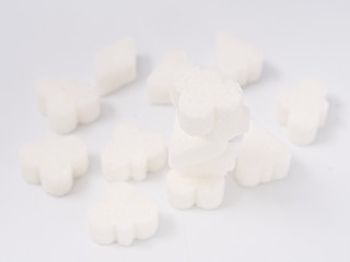 white lump sugar refined on a white background.