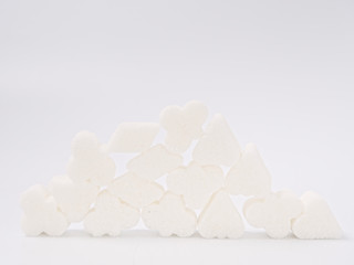 white lump sugar refined on a white background.