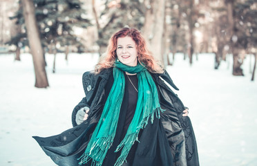 Redhead woman having fun in winter wonderland snow