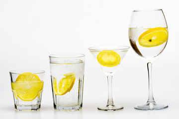 Hangover and detox. Detox after party. Health care concept. What to drink on party. Cocktail glasses with water slice of lemon isolated on white. Alcohol harmful influence. Detox drink to feel better