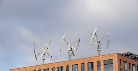  wind power generator turbines on an urban building roof                            