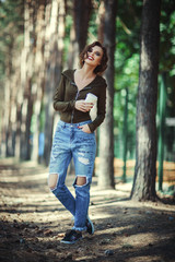 Beautiful model is posing with a paper cup