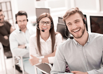rear view.employees of the call center looking at the camera