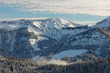 Fototapeta na wymiar Views of snowy Schoener Mann massif from Schwarzenberg