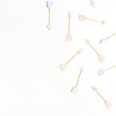 Paper Cupid arrow symbols on pink background. Flat lay, top view Valentines Day background love concept.
