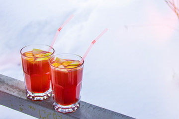 Glasses of mulled wine in snow.Hot wine in a glass.Morning in the mountains