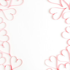 Wreath frame made of paper heart symbols on white background. Flat lay, top view Valentines Day background love concept.