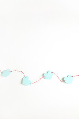 Flat lay, top view Valentines Day background with paper heart symbols and twine on white. Love concept.