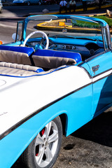 Old colorful vintage classic car on the streets of Havana, Cuba. American cars due to embargo are still used and serve as a taxi or transportation for tourists.