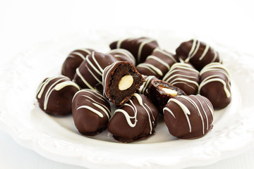 Handmade candies. prunes with chocolate almonds. Home sweetness. Selective focus.