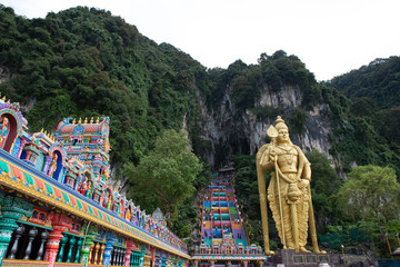 The Batu Caves Lord Murugan Statue and entrance near Kuala Lumpur Malaysia. A limestone outcrop located just north of Kuala Lumpur, Batu Caves has three main caves featuring temples and Hindu shrines.