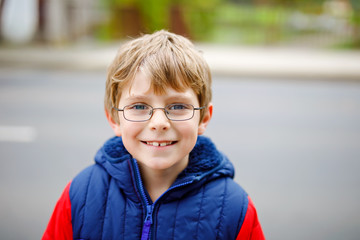 Portrait of little kid boy with glasses in colorful fashion fall clothing. Happy healthy child...
