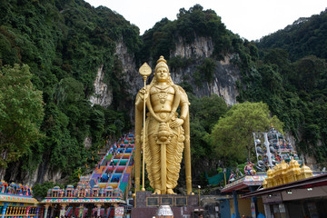 The Batu Caves Lord Murugan Statue and entrance near Kuala Lumpur Malaysia. A limestone outcrop located just north of Kuala Lumpur, Batu Caves has three main caves featuring temples and Hindu shrines.