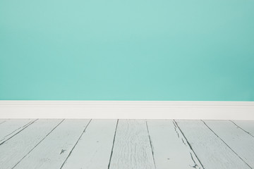 Empty studio living room with a wooden floor and blue wall paper background with copy space