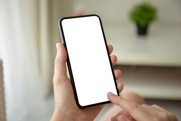 female hands holding phone with isolated screen in room