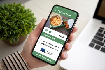 female hand holding touch phone with app delivery food