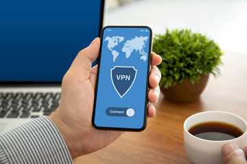 male hands holding phone with app vpn on the screen