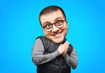 Funny portrait of a man with a big head on a blue, bright background.