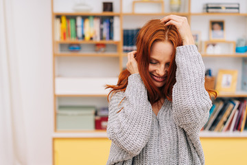 embarrassed young woman with her hands to her hair